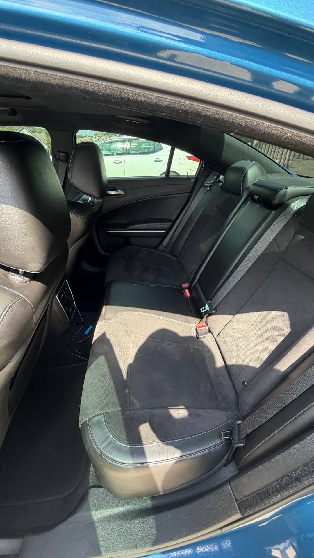 Dodge Charger rear leather and suede seats freshly detailed with the door open