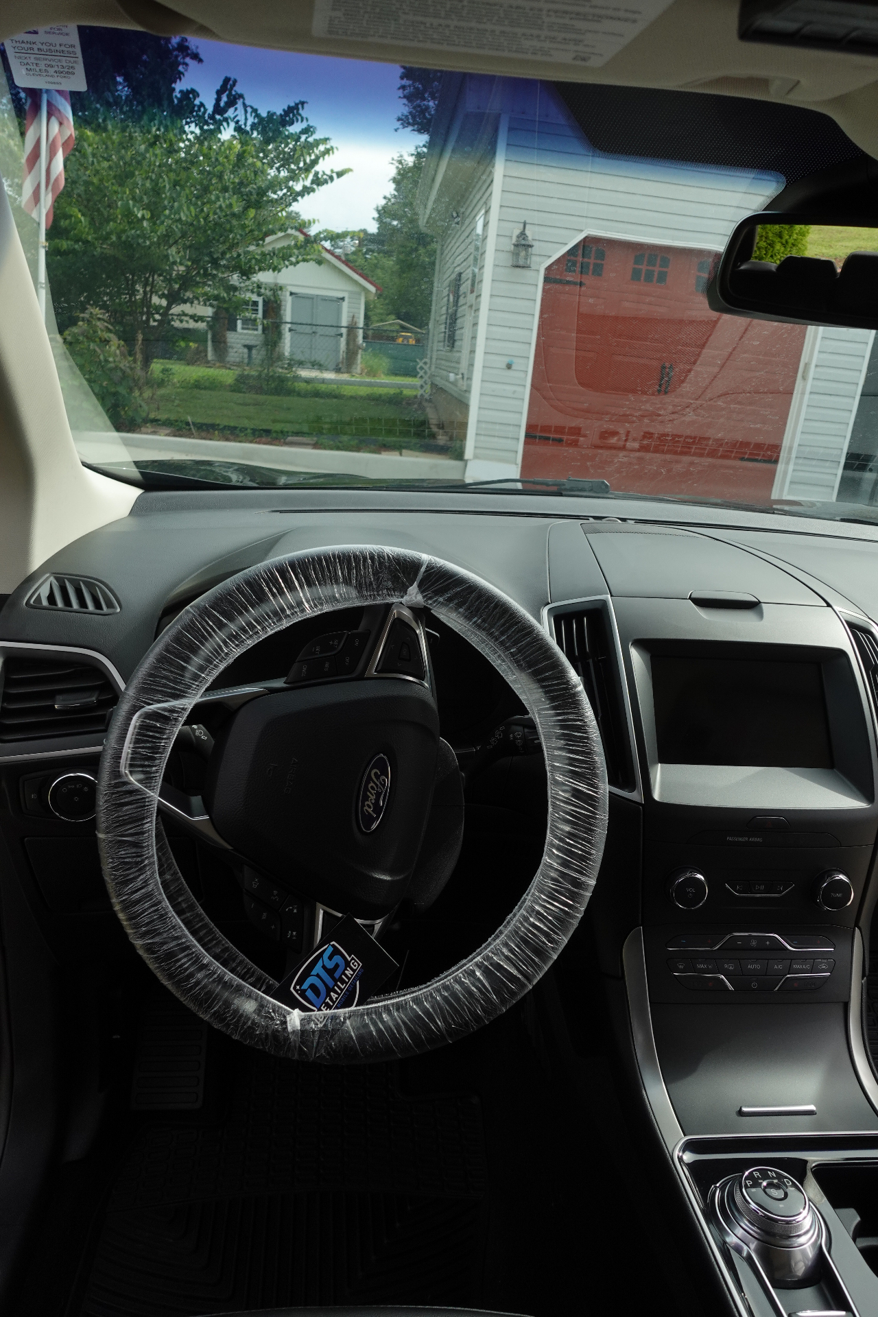 Ford Edge dashboard with DTS Detailing protective steering wheel cover during a mobile detail