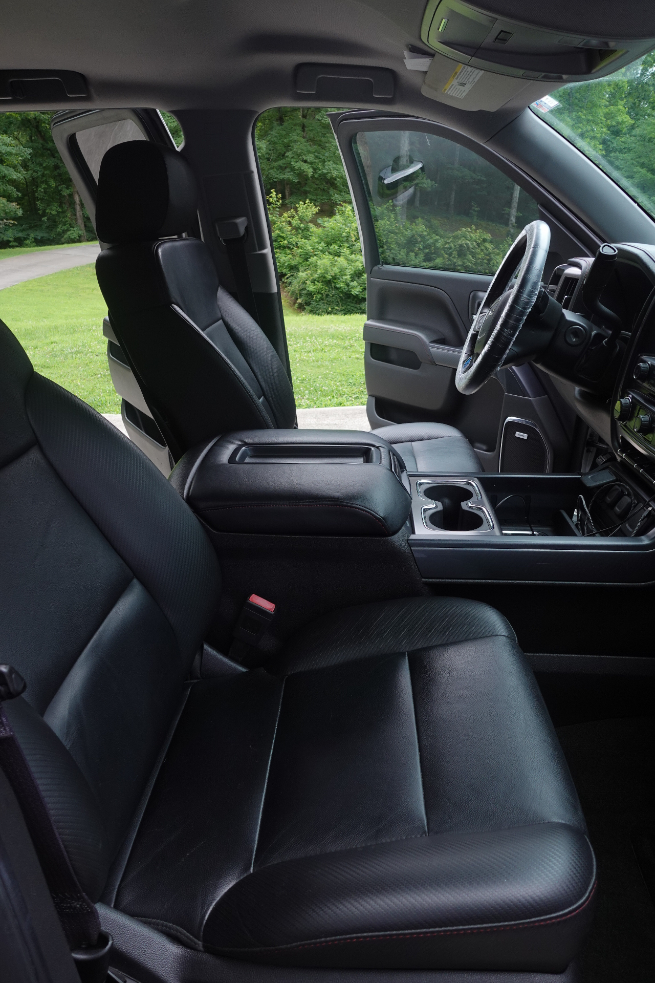 Spotless GMC Sierra black leather interior and center console after a full mobile detail