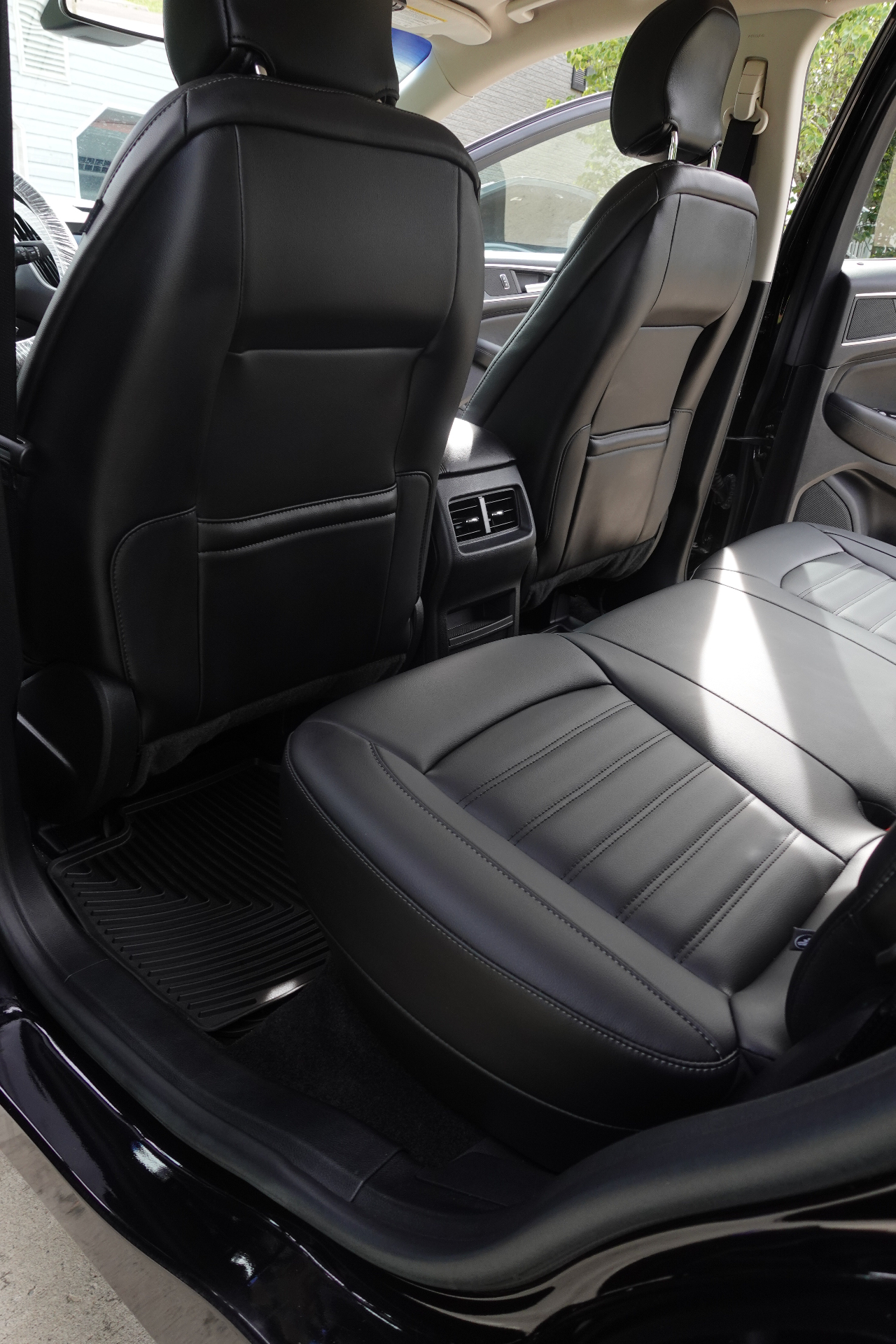Ford Edge rear leather seats freshly conditioned and rear floor mats cleaned after an interior detail