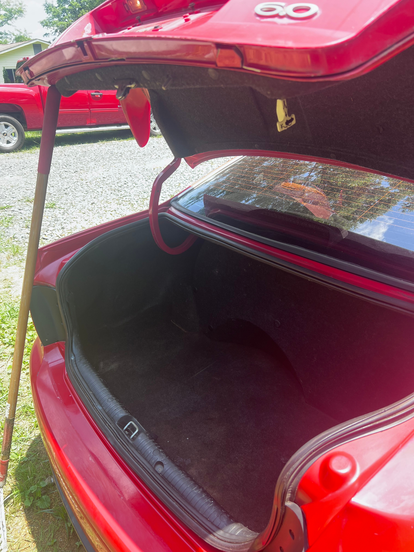 Same sedan trunk after DTS Detailing — spotless carpet, vacuumed and wiped down