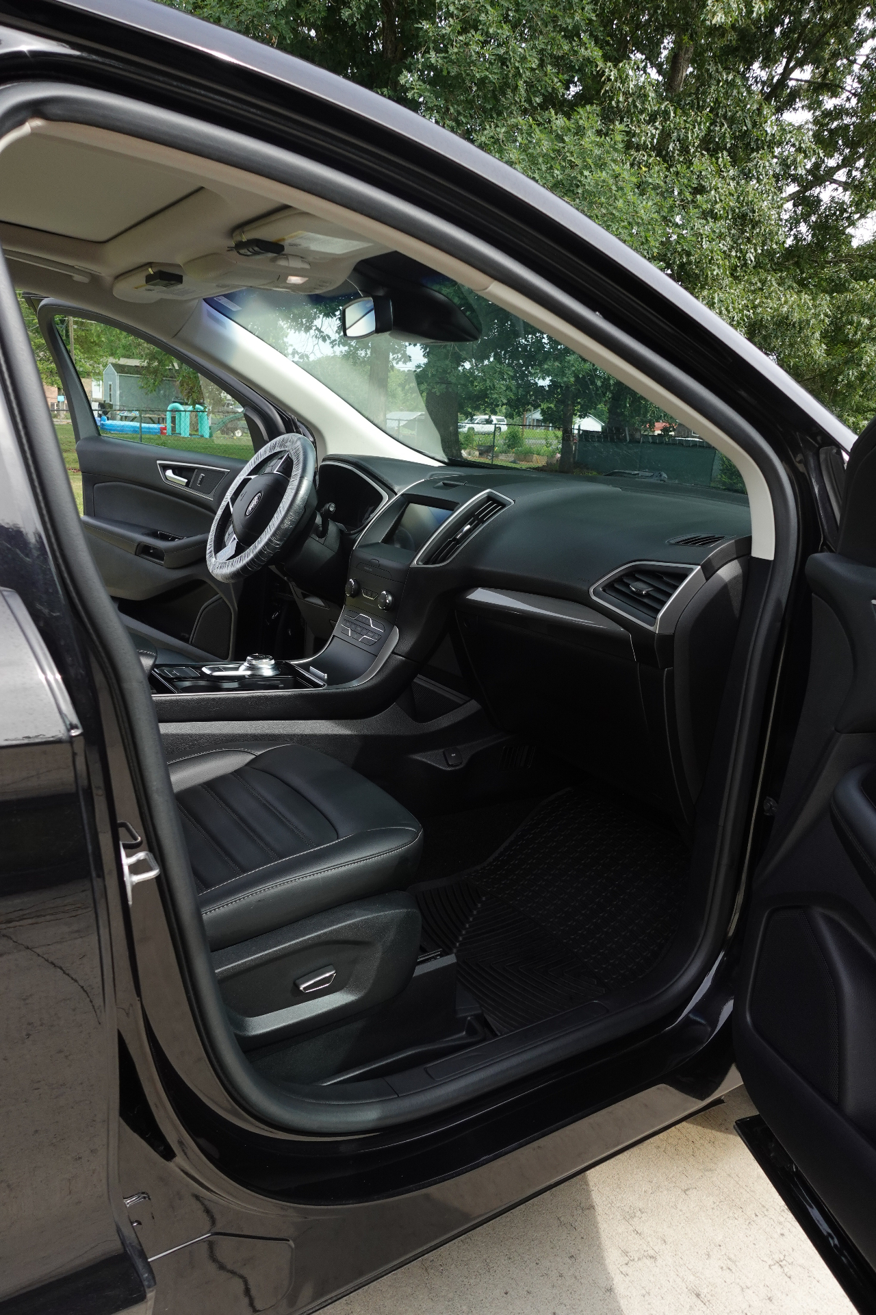 Ford Edge front passenger area cleaned top to bottom with conditioned seats and spotless trim