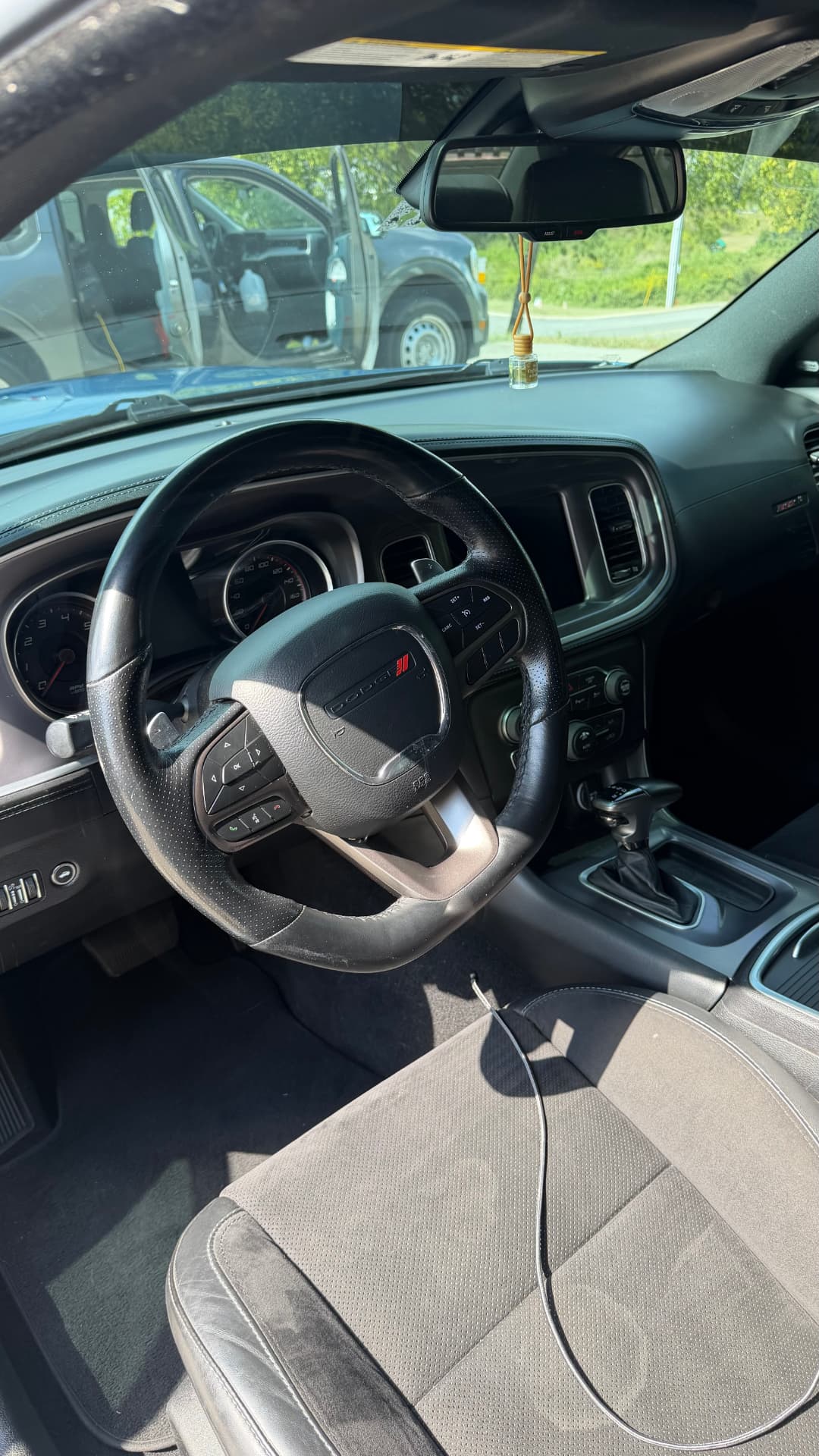 Dodge Charger dashboard, steering wheel, and console cleaned during an interior detail