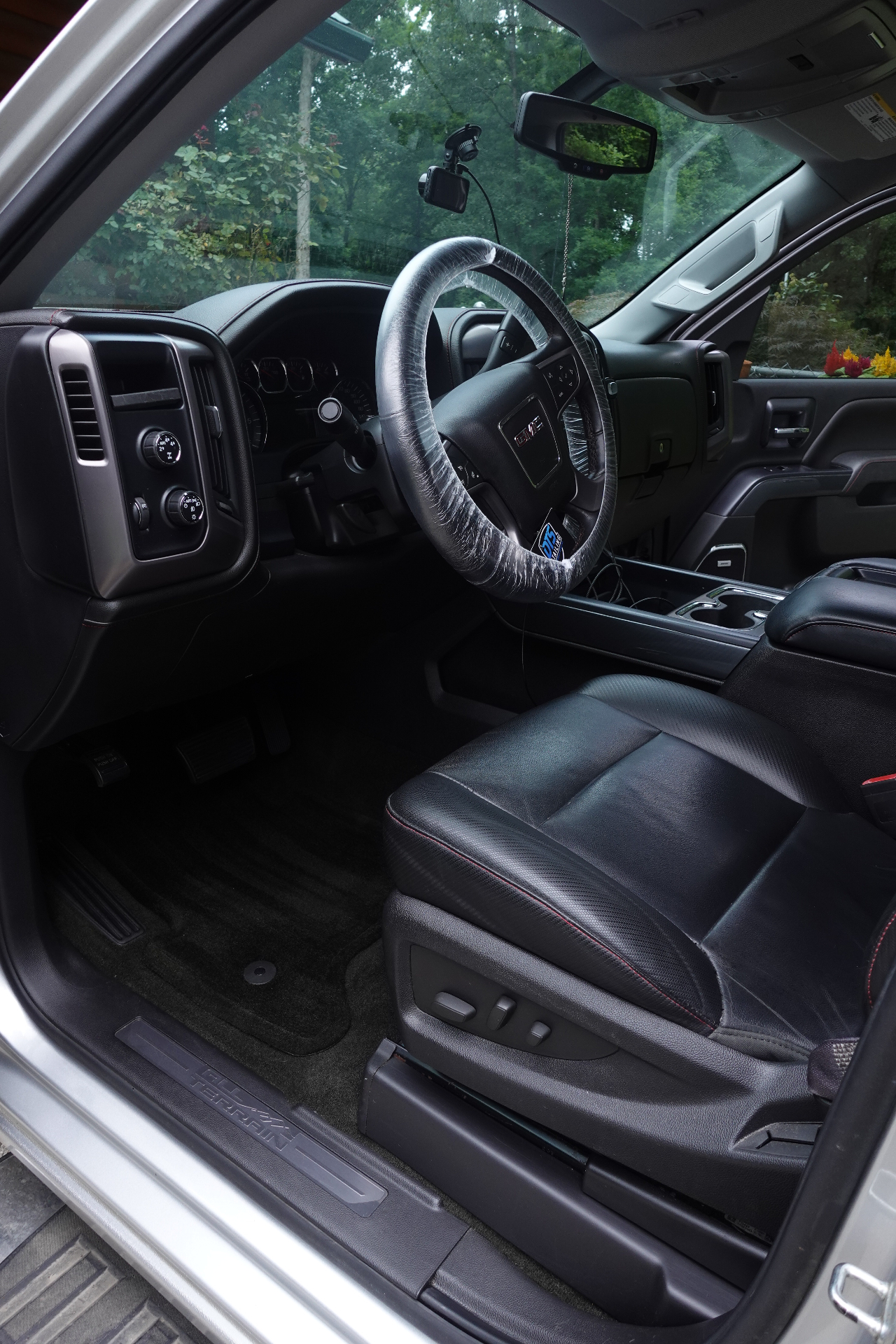 Freshly detailed GMC Sierra driver seat and cabin with shampooed carpets and conditioned leather