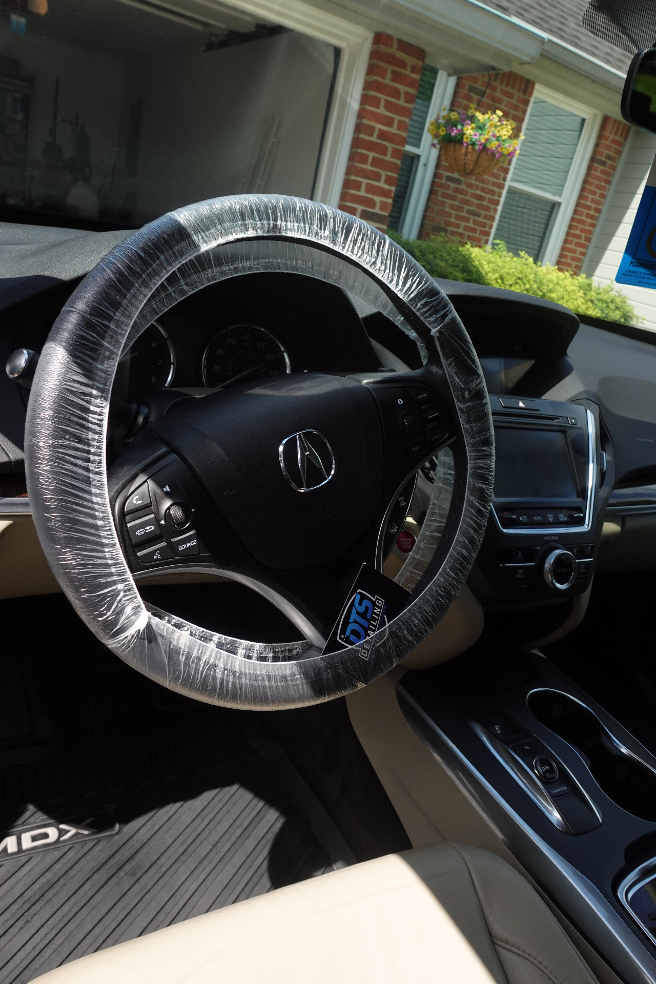 Acura MDX front cabin with DTS Detailing protective steering wheel cover during an interior service